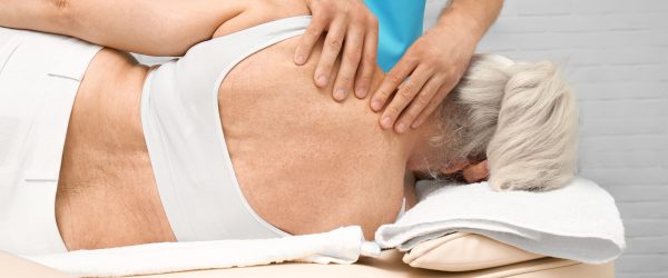 Elderly woman getting massage at physical therapy office